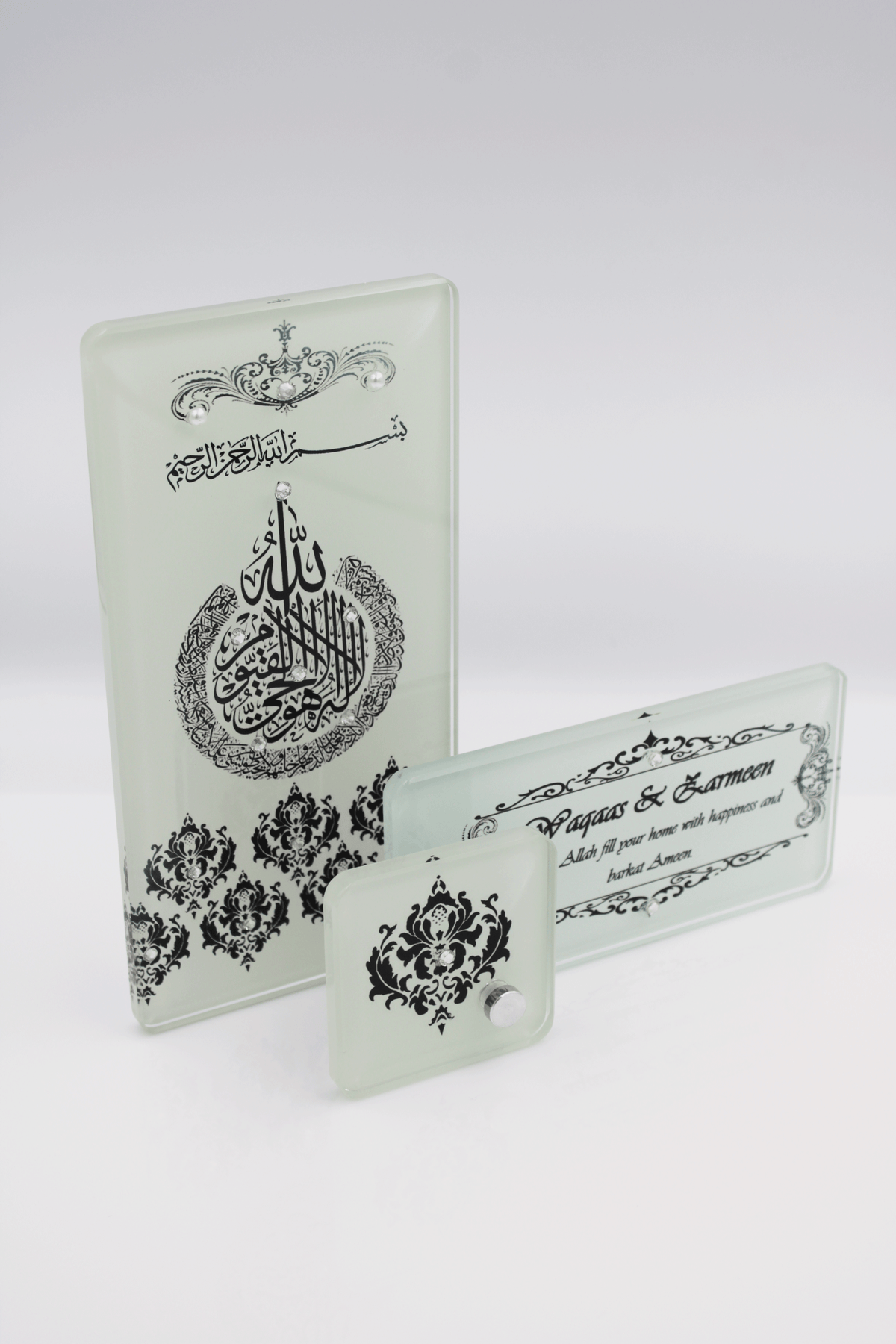 A set of three connected picture frames with Arabic calligraphy and decorative elements in black, clear, and ivory colors.